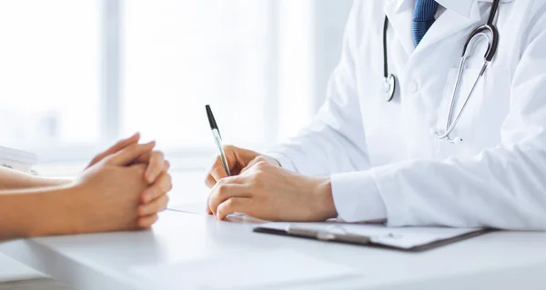 depositphotos 71002415 stock photo patient and doctor taking notes